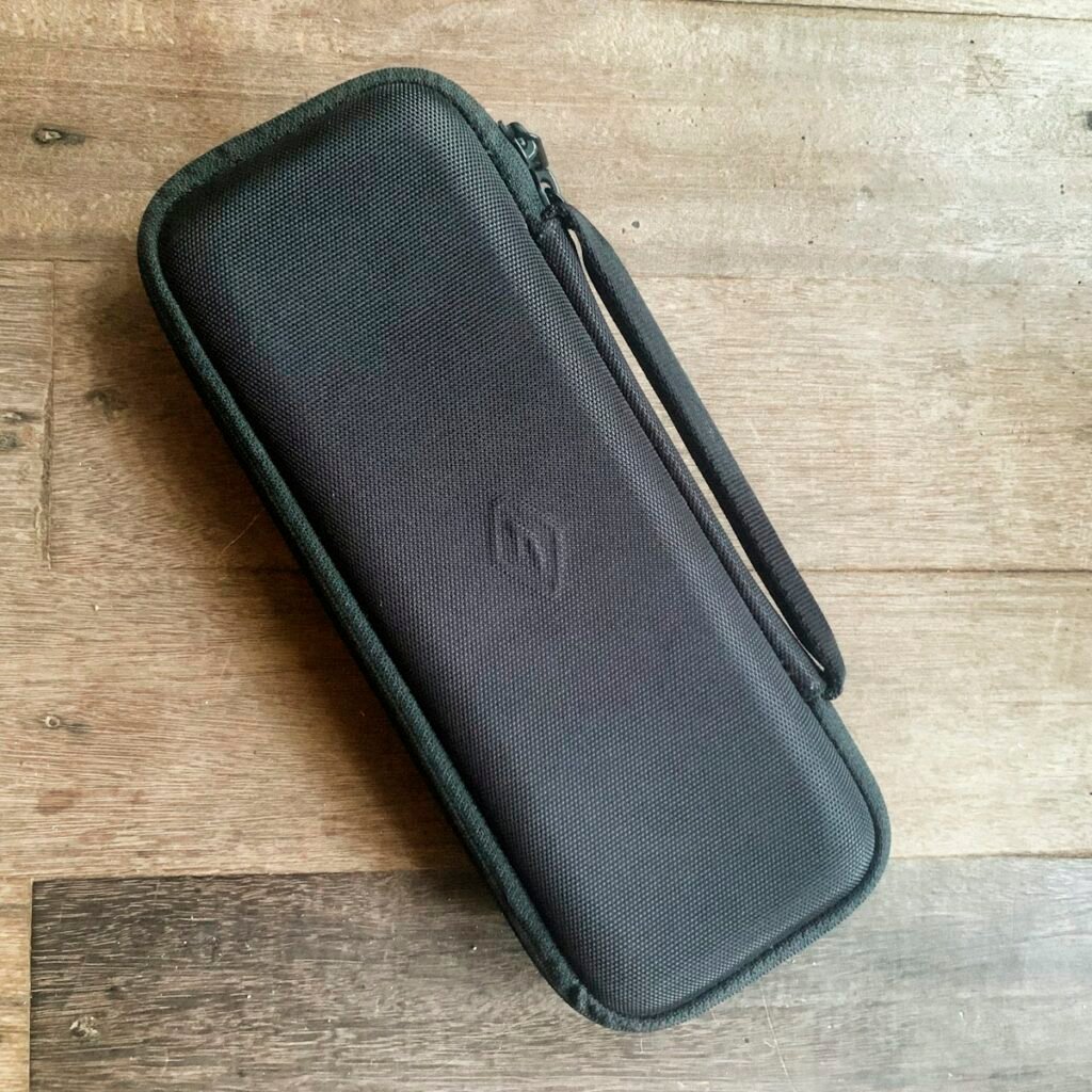 Hard-shell keyboard travel case on a wooden table