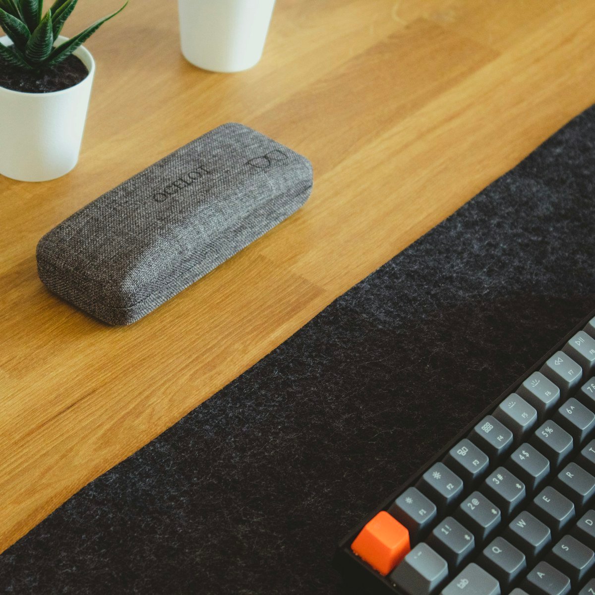 Memory foam keyboard wrist rest on a wooden desk