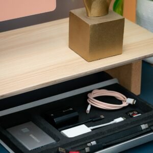 Under-desk cable tray holding chargers and cables