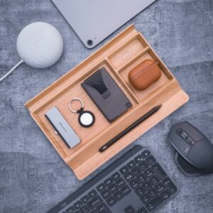 Walnut desk tray with keys, pen and earbuds
