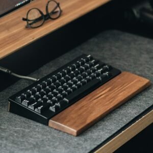 Walnut wrist rest with a compact mechanical keyboard