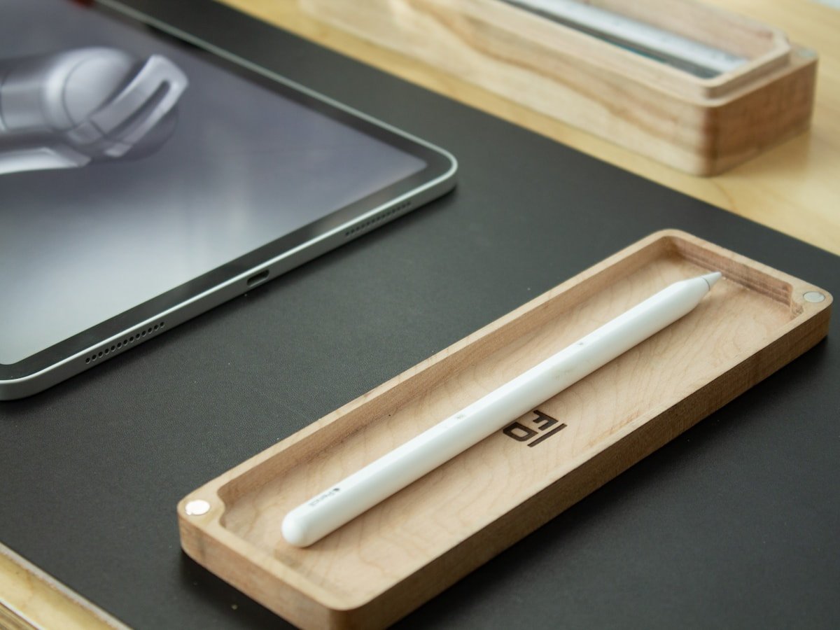 Wooden desk tray with a pen